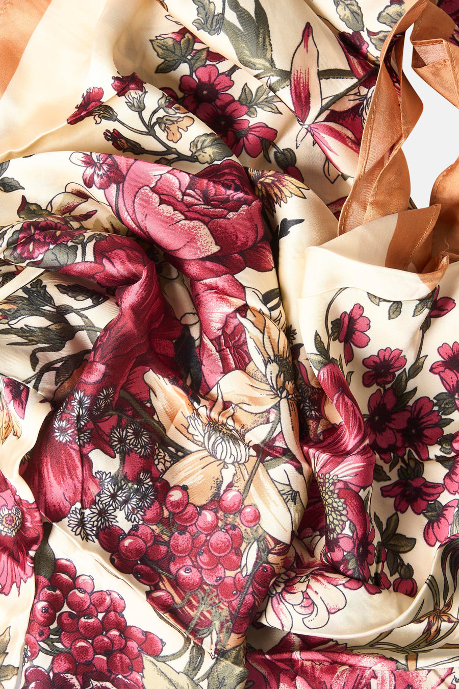 Multicolored floral foulard with cream base, red roses, berries, and green leaves, soft satin texture, close-up view