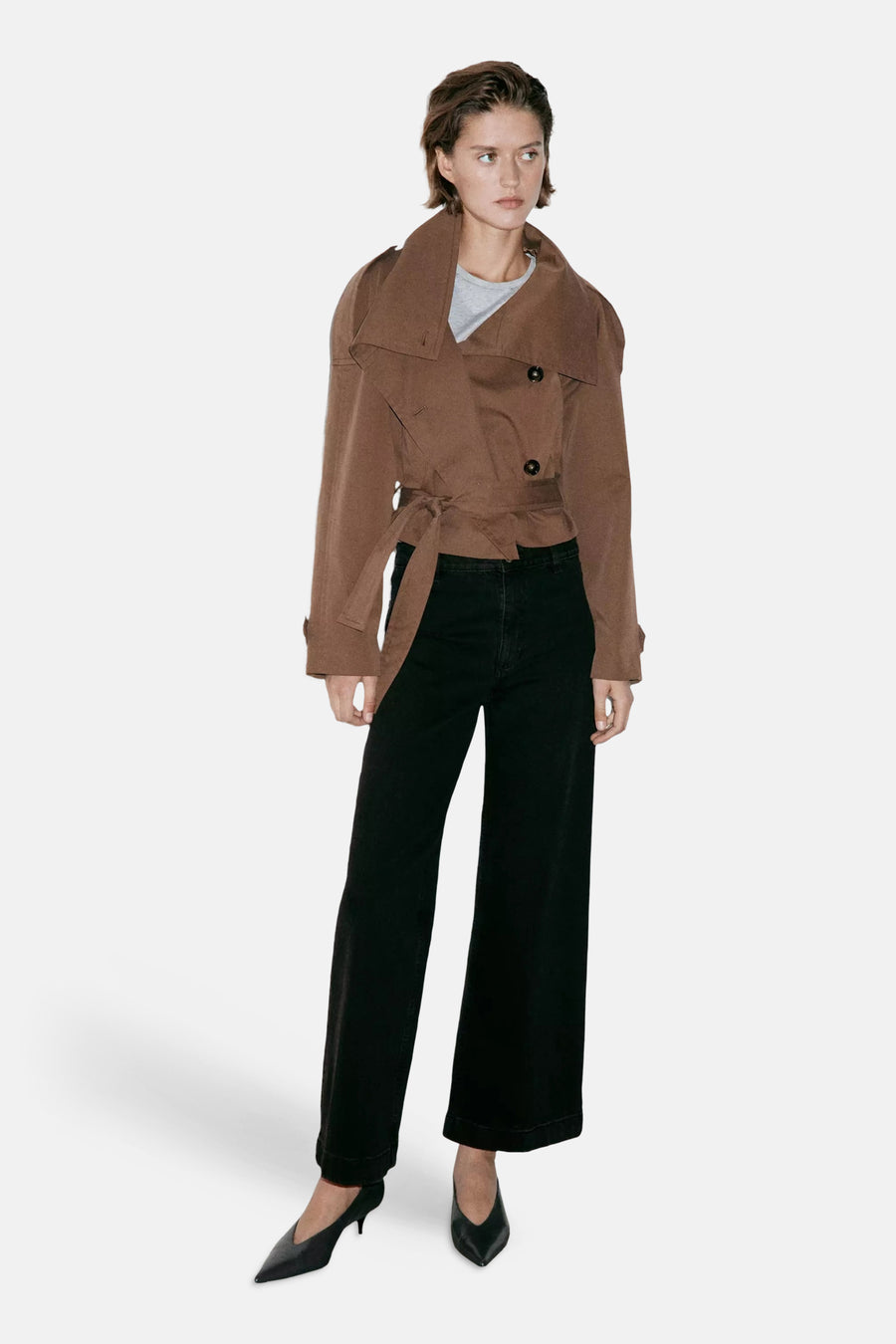 Black wide-leg denim jeans by CATHERIN, featuring cuffed hems and a straight fit, shown with brown jacket and pointed heels in full-length lifestyle view