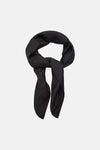 Black silk foulard with subtle dot pattern, by MANGO, styled in elegant knot against white background