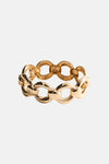 Gold-toned chain-link bracelet with polished oval links and interlocking design, shown in front view.