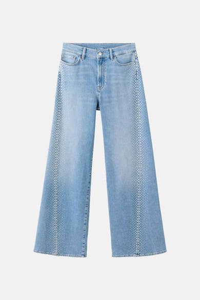 Light blue wide-leg denim jeans with studded side detailing, front view