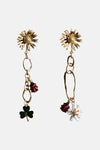 Multicolored dangle earrings with gold-tone floral tops, chain links, and charms including red ladybugs, green clovers, and white flowers, shown front view.