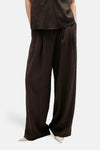Brown textured wide-leg chinos with vertical ribbed pattern, shown front view on model wearing matching top and white pointed-toe shoes.