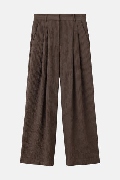 Brown textured chino trousers with wide legs and front pleats, front view