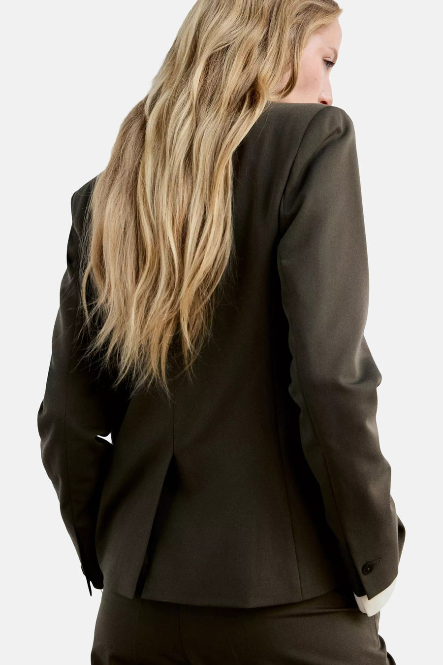 Khaki blazer with structured shoulders and single-button closure, back view showing clean lines and tailored fit on model with wavy blonde hair