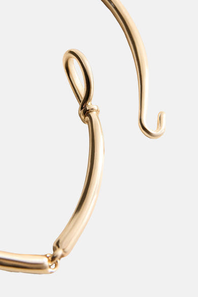 Gold-toned short necklace with sleek curved links and polished finish, close-up side view