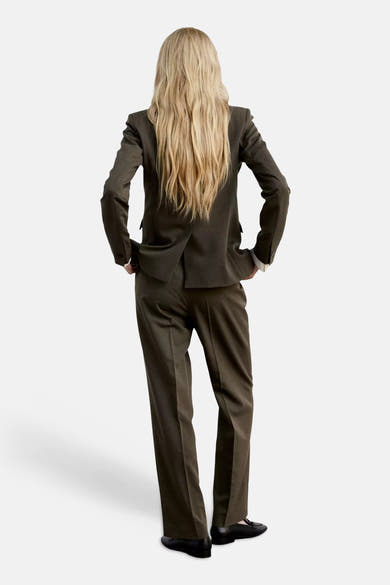 Khaki suit pants with straight-leg cut, shown from back view on model wearing matching blazer and black loafers