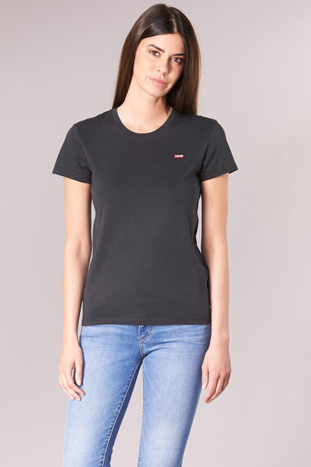 T-shirt noir à manches courtes de Levi's, avec logo rouge sur la poitrine, porté avec un jean bleu.
