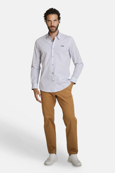 Multikleurig overhemd met lange mouwen van DELAHAYE met subtiel geometrisch patroon, gedragen met een bruine broek en witte sneakers.
