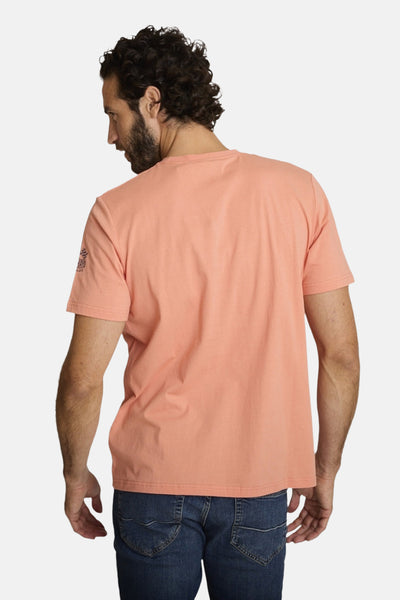 Orange polo shirt back view with small logo on sleeve, worn with blue jeans
