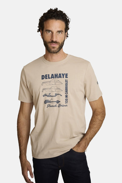 Beige polo shirt with vintage car graphic and text, front view on model wearing dark jeans