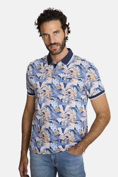 Polo bleu de DELAHAYE, à motifs tropicaux, porté avec un jean.