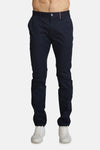 Marineblauwe chino van DELAHAYE, met roze biezen op de achterzakken, gedragen met witte sneakers.