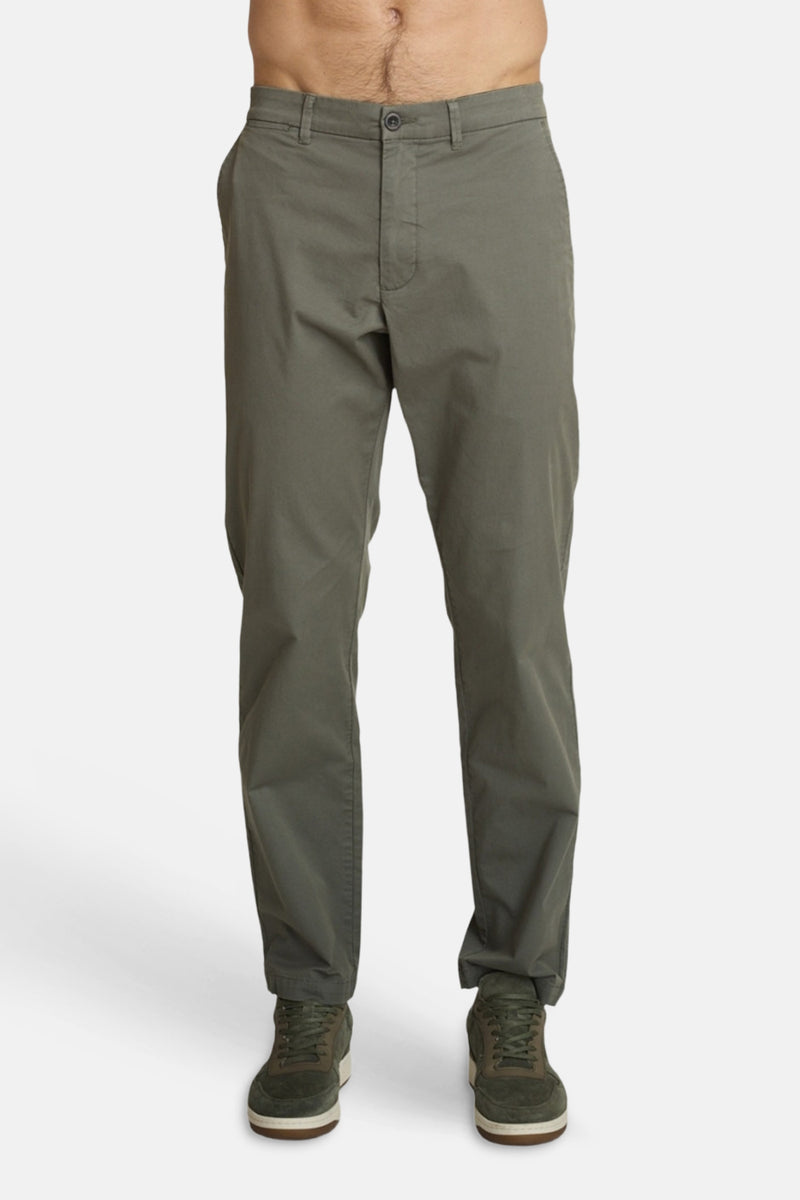 Olive green slim-fit joggers by DELAHAYE, front view, with button fly and cuffed hems, worn with dark green sneakers.