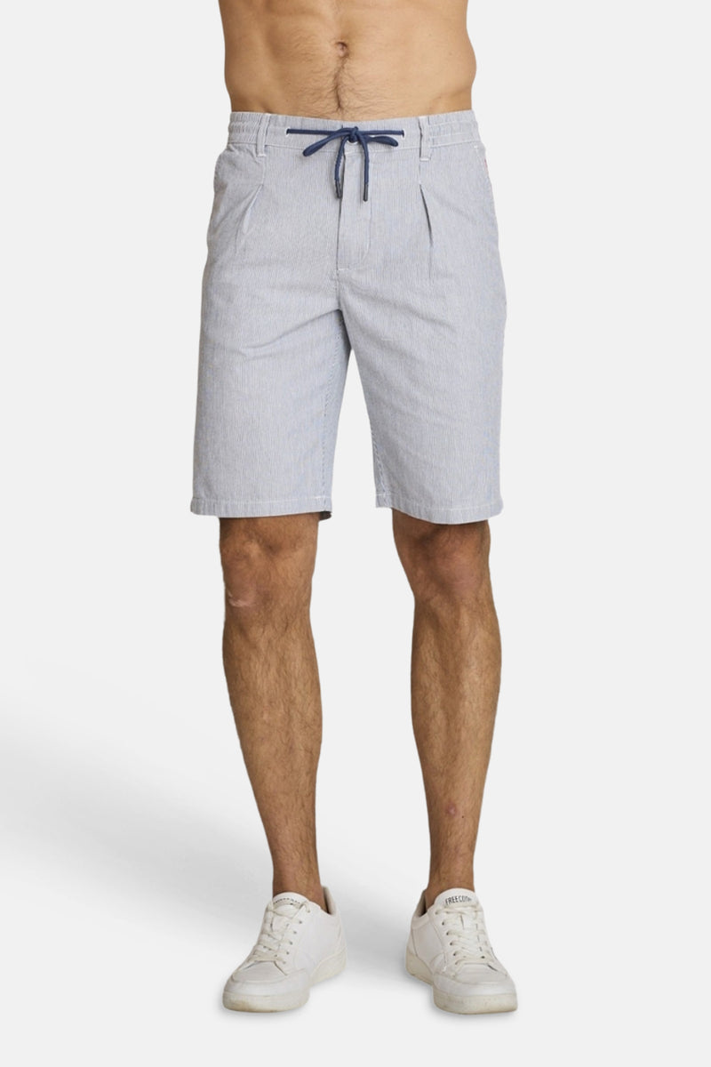 Light blue striped cotton bermuda shorts by DELAHAYE, featuring drawstring waist and front pockets, shown on model with white sneakers.