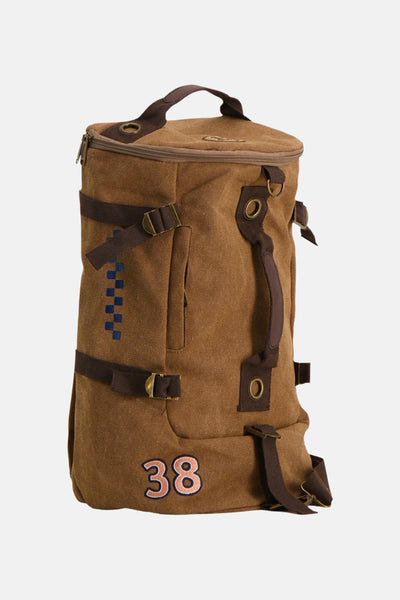 Beige canvas backpack with brown straps and brass buckles, featuring blue checkered pattern and embroidered number 38, front view