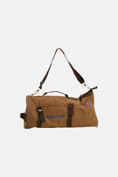 Beige canvas duffel bag with blue checkered pattern and pink logo, featuring adjustable straps and front pockets, shown in front view.