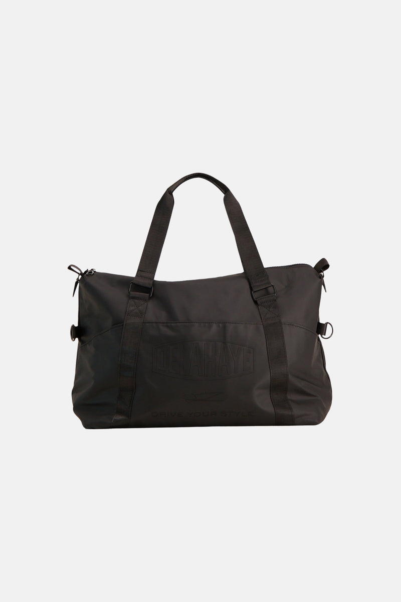 Black shoulder bag by Delahaye with embossed logo, front zip pockets, and adjustable straps, shown front view.