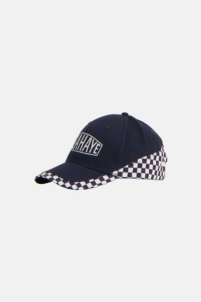 Navy blue baseball cap with white checkered brim and side panels, featuring embroidered logo on front, side view.