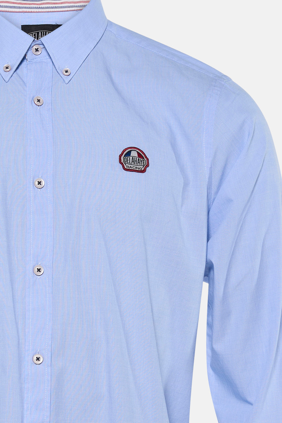 Light blue long-sleeve shirt by Delahaye with racing patch, button-down front, and striped collar detail, close-up view