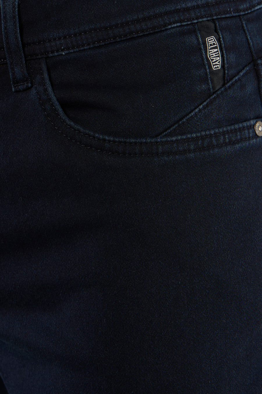 Dark blue chino pants by Delave, close-up back view showing textured twill fabric and branded pocket tab.