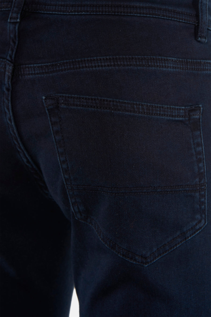 Dark blue chino pants back view with stitched pocket and textured fabric, close-up detail