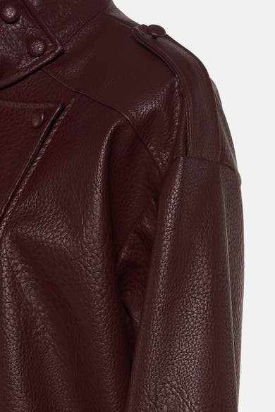 Bordeaux leather bomber jacket with textured surface and snap buttons, side view close-up