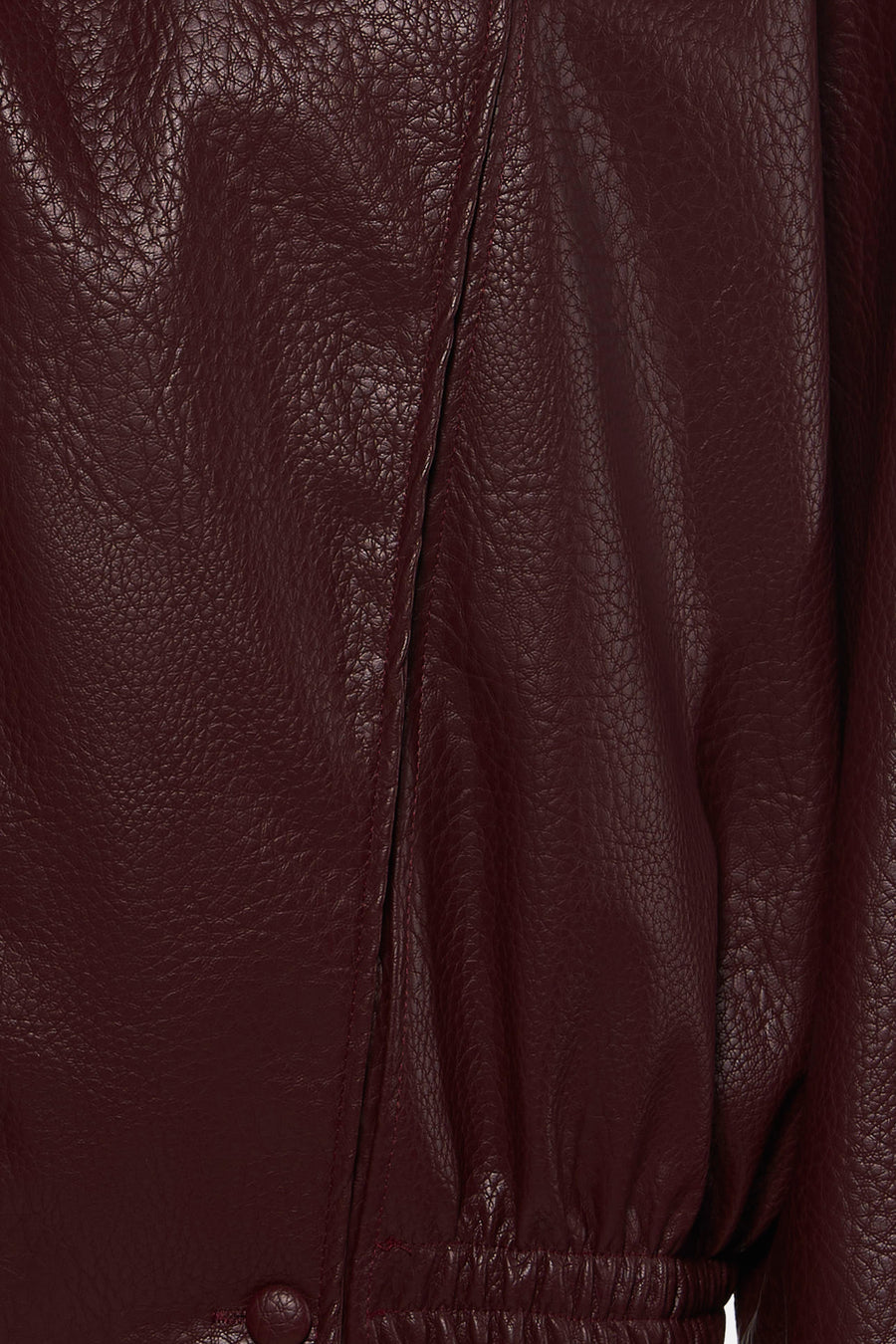 Bordeaux leather bomber jacket with textured surface and elasticated hem, close-up front view