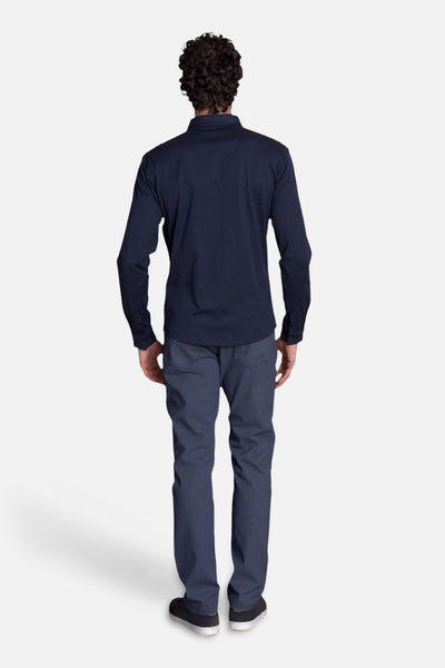 Navy blue long-sleeve chemise back view, smooth cotton blend fabric, paired with dark gray trousers and black sneakers