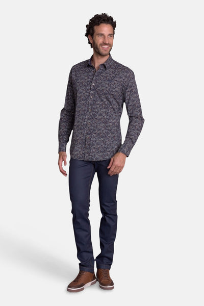 Blue patterned long-sleeve chemise with floral print, worn by model in full-length front view with dark jeans and brown shoes
