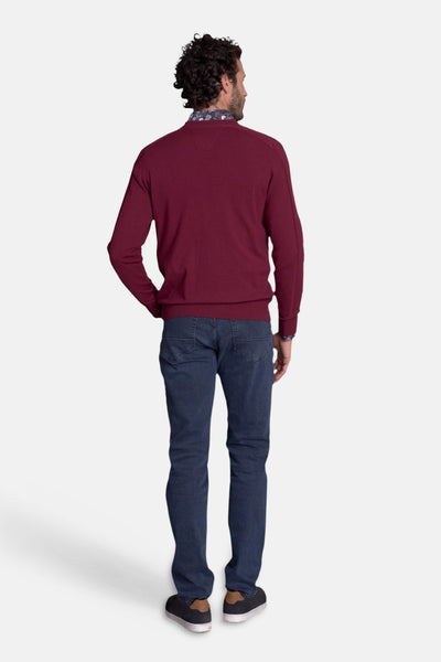 Burgundy crewneck sweater with floral collar lining, back view, worn with blue jeans and black sneakers