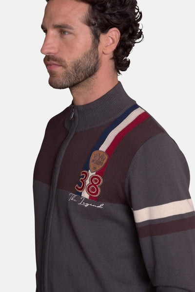 Brown and gray knit gilet with red, white, and blue shoulder stripes, number 38 embroidery, and "The Legend" script, side view