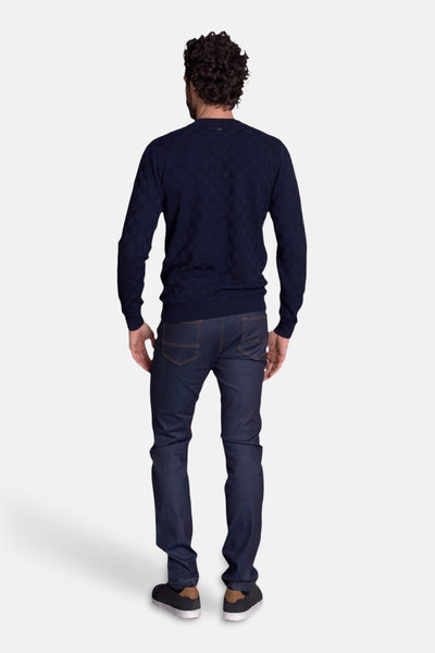 Navy long-sleeve polo with subtle check pattern, back view, worn with dark jeans and sneakers