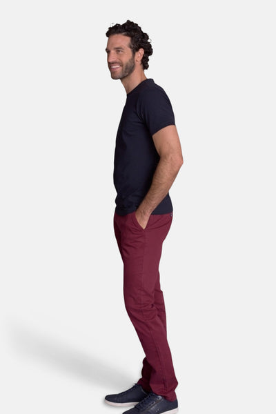 Navy blue men's t-shirt side view, plain cotton, short sleeves, crew neck, worn with burgundy trousers and navy sneakers