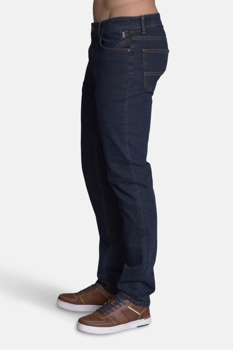 Slim jeans in medium blue denim from DELAHAYE, with brown shoes with white soles.