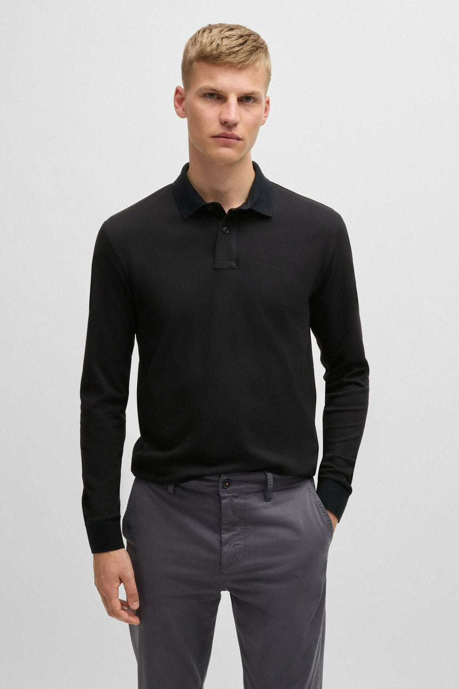 Zwarte polo met lange mouwen van BOSS ORANGE, met een klassieke kraag in dezelfde kleur en een discrete knoopsluiting.
