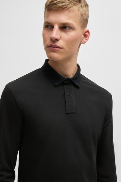 Polo à manches longues noir de BOSS ORANGE, avec col classique ton sur ton et patte de boutonnage discrète.
