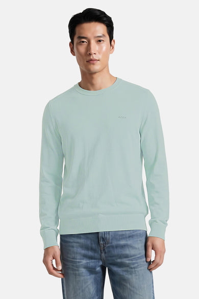 Turquoise crewneck sweater by BOSS, ribbed cuffs and hem, subtle logo on chest, front view, worn with blue jeans