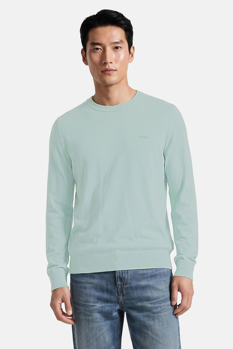 Turquoise crewneck sweater by BOSS, ribbed cuffs and hem, subtle logo on chest, front view, worn with blue jeans
