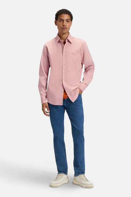 Roze gemêleerd overhemd met lange mouwen van BOSS Orange, gedragen met een oranje T-shirt en een blauwe jeans.