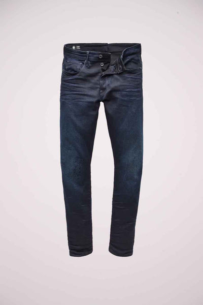 G-Star RAW blauwe slim fit jeans, met subtiele verkleuring over het geheel en een knoopsluiting.