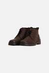 Brown leather ankle boots by Palladium, featuring black laces, side eyelets, and a rugged rubber sole, front view.