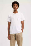 Wit T-shirt van Levi's, gedragen met een beige broek met trekkoord.