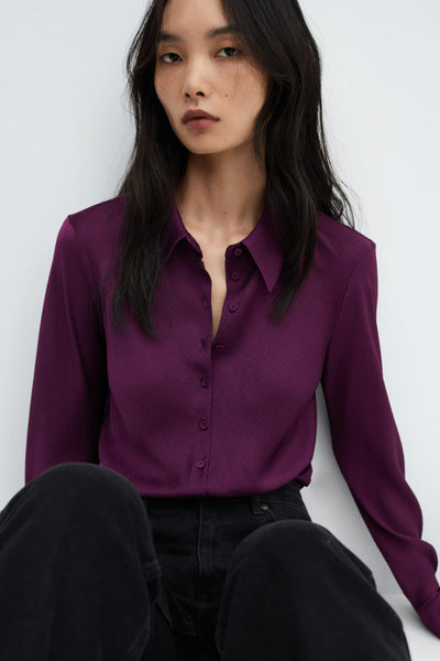 Mauve long-sleeve blouse with ribbed texture and button-down front, worn with dark jeans in a cropped lifestyle view