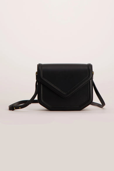 Black leather crossbody bag with flap closure and adjustable strap, front view