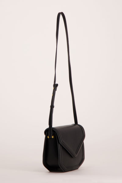Black leather crossbody bag with flap closure and adjustable strap, side view