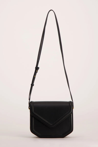 Black leather crossbody bag with flap closure and adjustable strap, front view