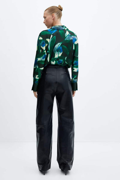 Green floral long-sleeve blouse with blue and white accents, back view, paired with black wide-leg trousers