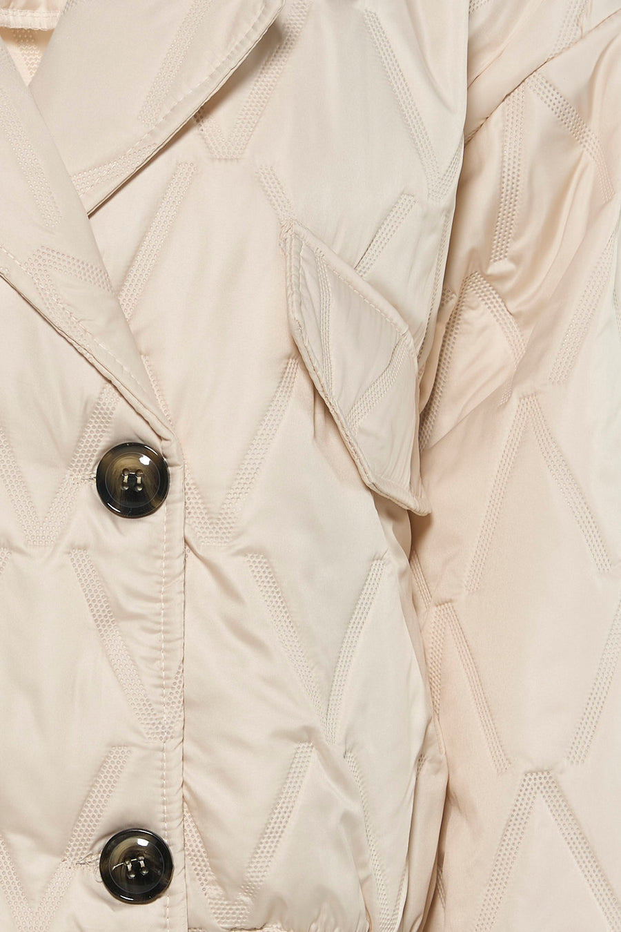 Ecru quilted women's casual jacket with diamond stitching and black buttons, close-up front view