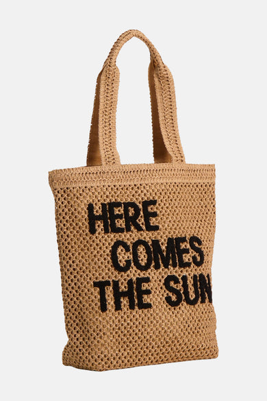 Sac à bandoulière beige de MORE & MORE avec inscription noire "Here Comes The Sun" et une texture tressée.
